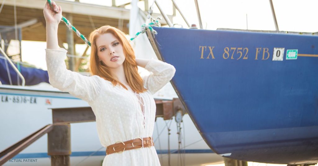 Beautiful woman (model) posed in front of a boat.